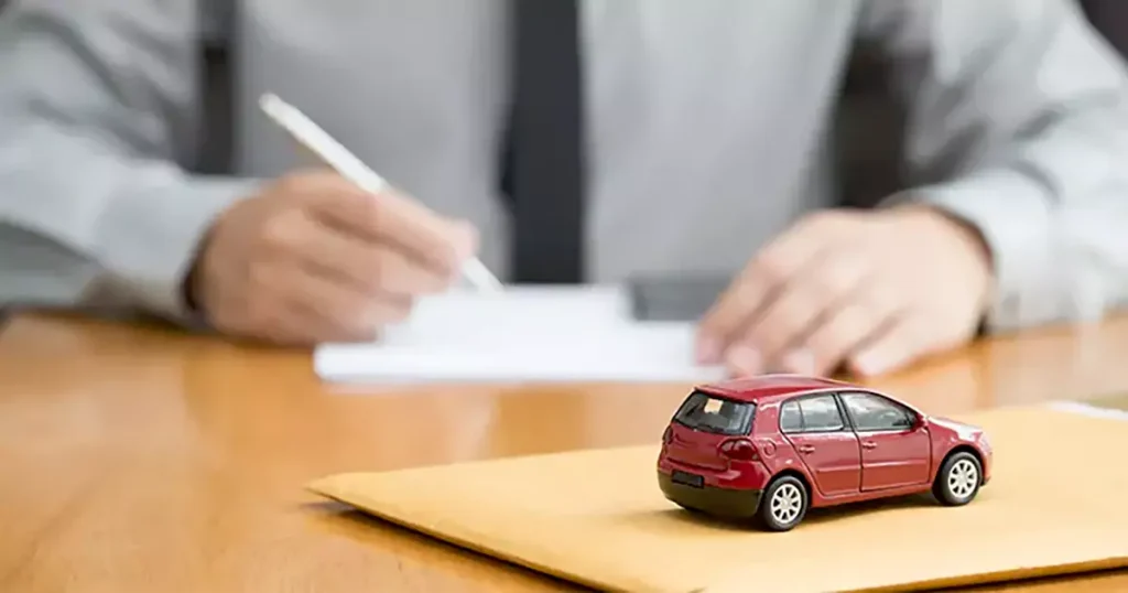 یک کارمند درحال امضا کردن قرار داد برای خرید خودرو