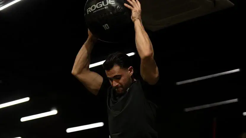 مردی درحال بلند کردن وزنه و اشتباهات رایج تمرین ورزشی